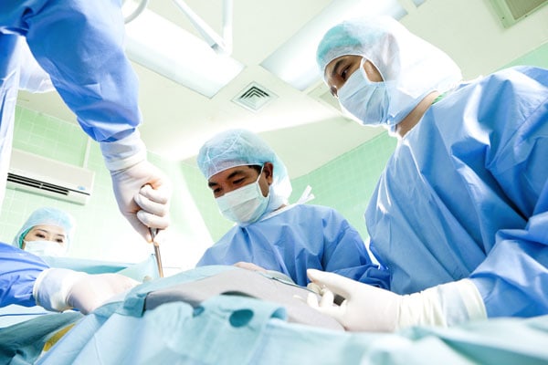 surgeons operating on a patient's back