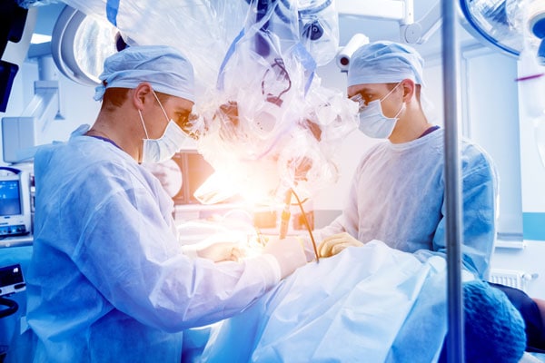 surgeons working in the OR on a spine